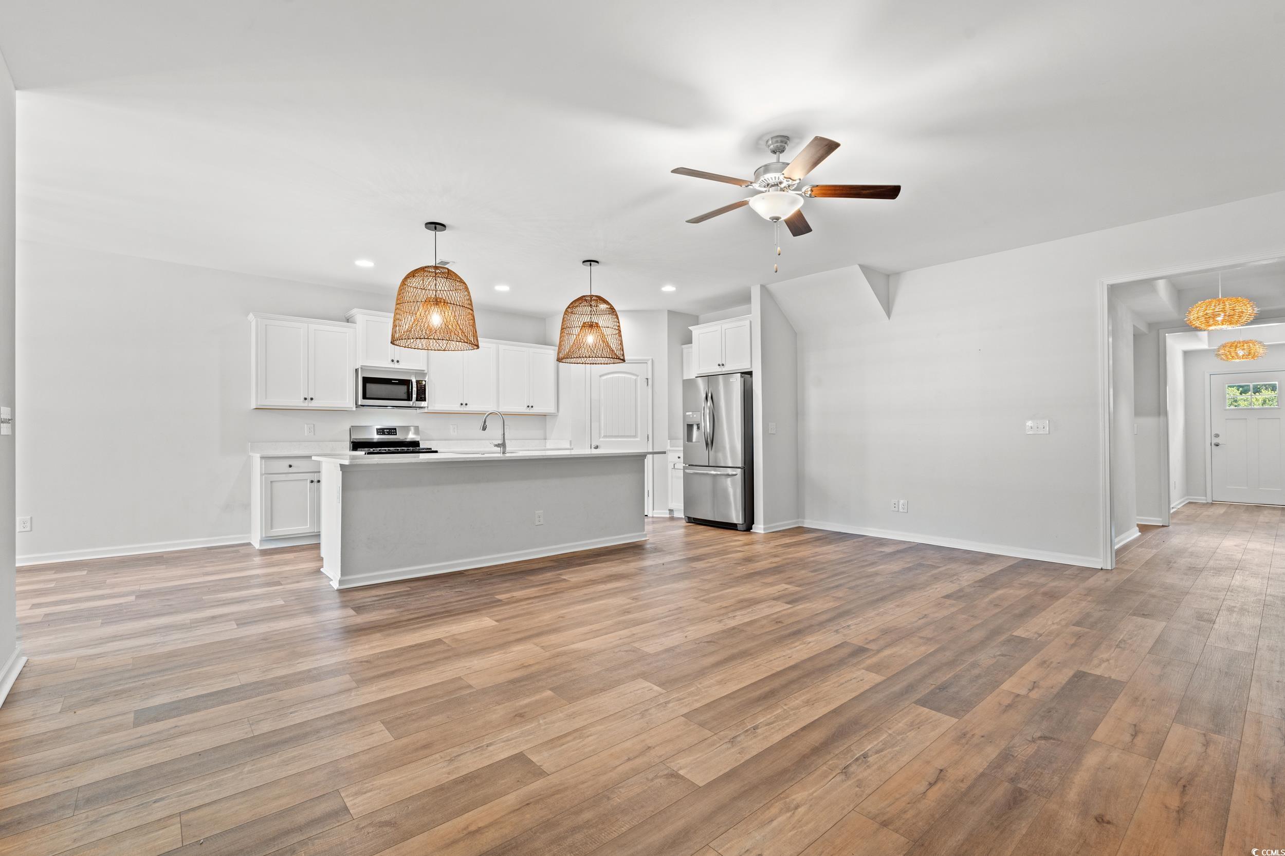 3026 Millstone Place Georgetown, SC 29440 - Photo 33 of 34 Kitchen featuring open floor plan, recessed lighting, appliances with stainless steel finishes, light wood-type flooring, and a ceiling fan
