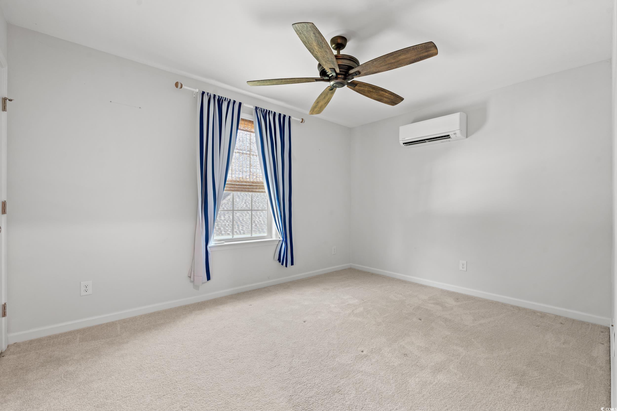 3026 Millstone Place Georgetown, SC 29440 - Photo 19 of 34 Empty room featuring a ceiling fan, light carpet, and a wall mounted AC
