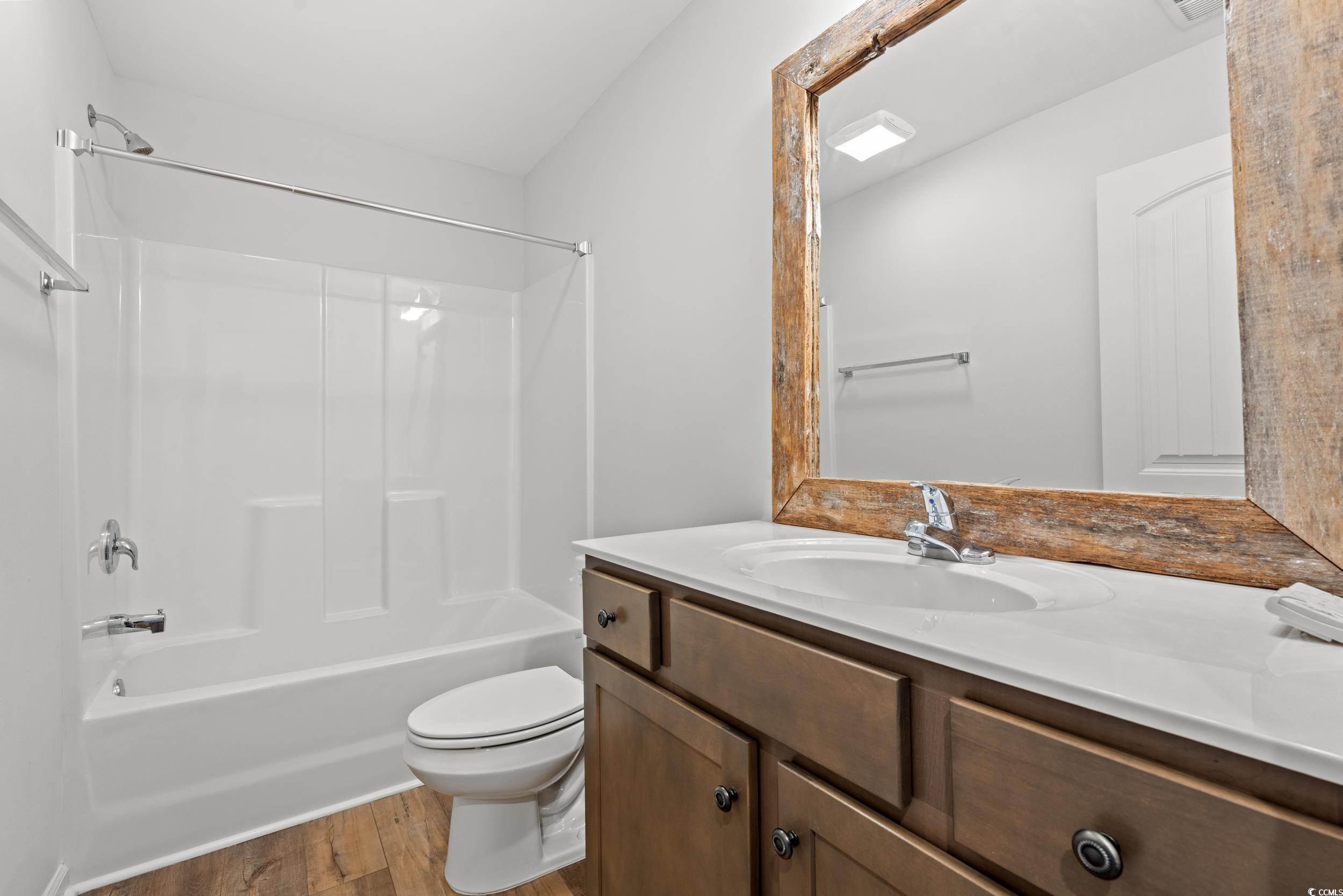 3026 Millstone Place Georgetown, SC 29440 - Photo 20 of 34 Full bathroom with wood finished floors, vanity, and shower / bathtub combination, located upstairs