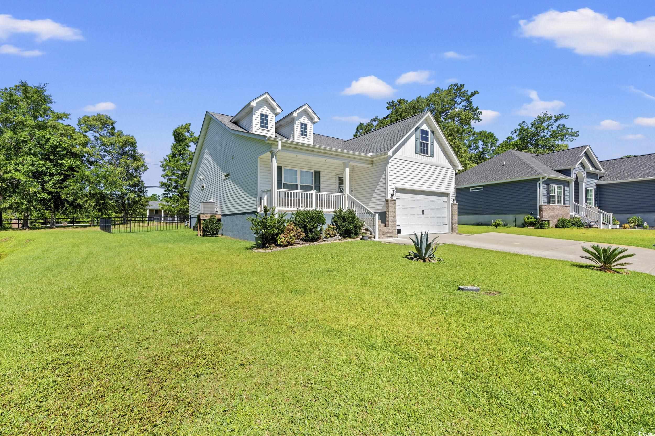 3026 Millstone Place Georgetown, SC 29440 - Photo 26 of 34 View of front facade with a garage, a porch, and concrete driveway