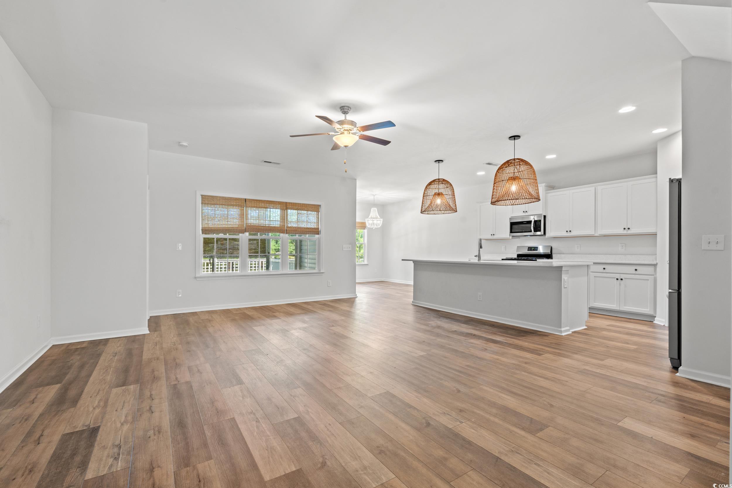 3026 Millstone Place Georgetown, SC 29440 - Photo 3 of 34 Unfurnished living room featuring ceiling fan, recessed lighting, and light wood finished floors