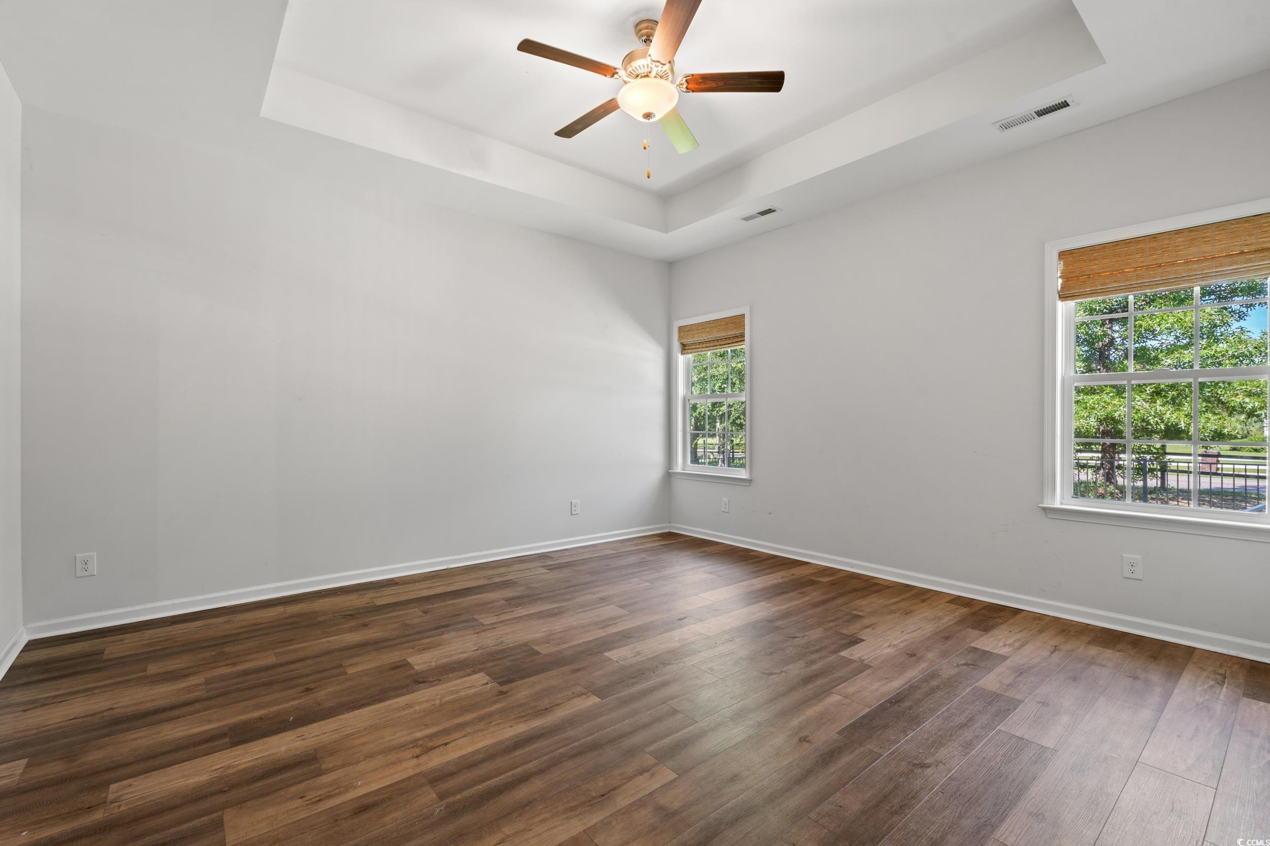3026 Millstone Place Georgetown, SC 29440 - Photo 5 of 34 Unfurnished room featuring a tray ceiling, a ceiling fan, and LVP flooring