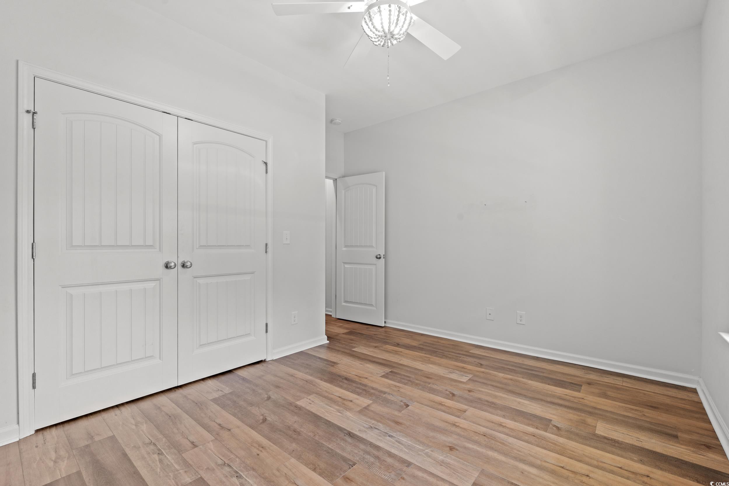 3026 Millstone Place Georgetown, SC 29440 - Photo 10 of 34 Unfurnished bedroom with LVP flooring, a closet, and ceiling fan