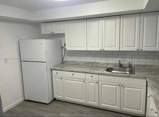 a kitchen with appliances cabinets and a counter top space