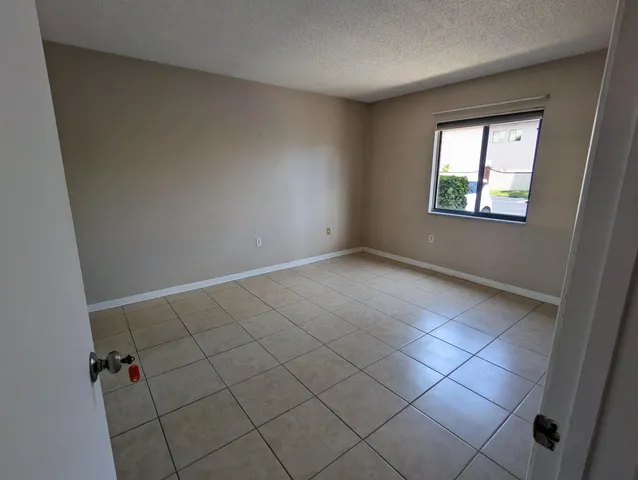 an empty room with a mirror and a sink