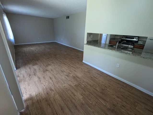 a view of a kitchen with a sink and a refrigerator