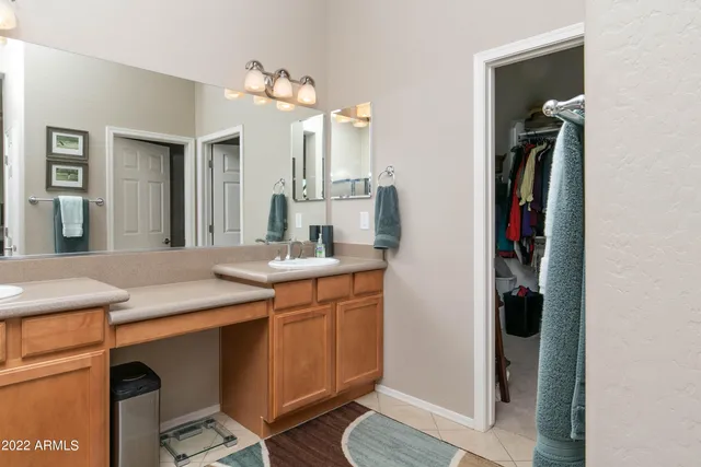 a bedroom with a bed next to a window and a flat screen tv