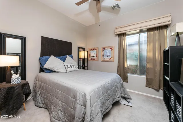 a bedroom with a bed and a window