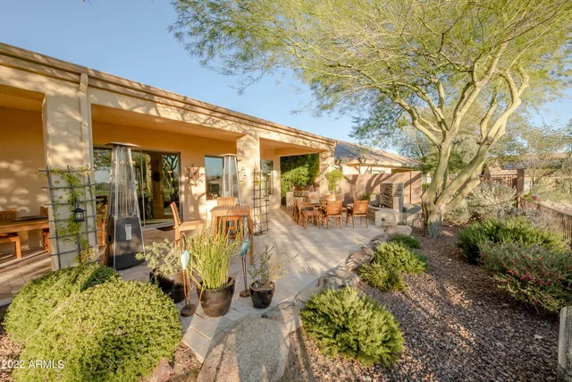 a bedroom with furniture and large windows