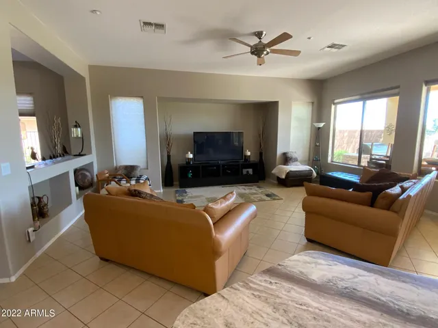 a view of a terrace with furniture and a lake