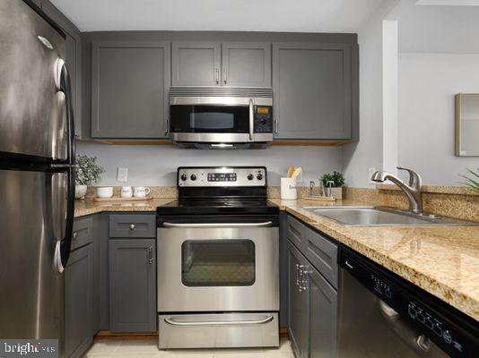 1150 K Street Northwest, Unit 709 Washington, DC 20005 - Photo 12 of 25 a kitchen with stainless steel appliances granite countertop a sink stove and refrigerator