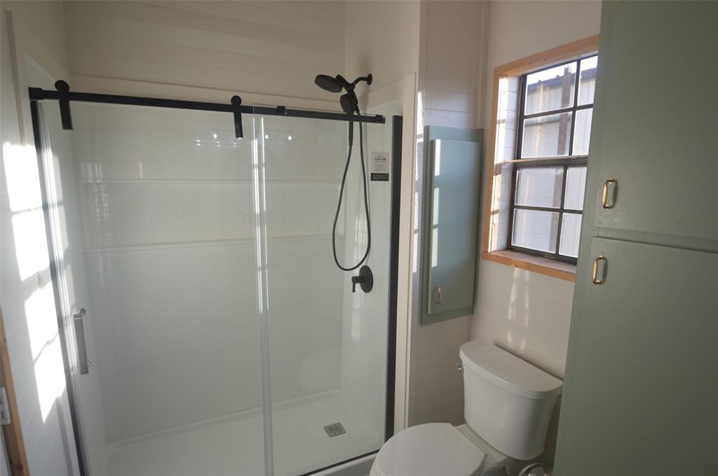 261 Red Road Howe, TX 75459 - Photo 23 of 40 a bathroom with a shower and toilet