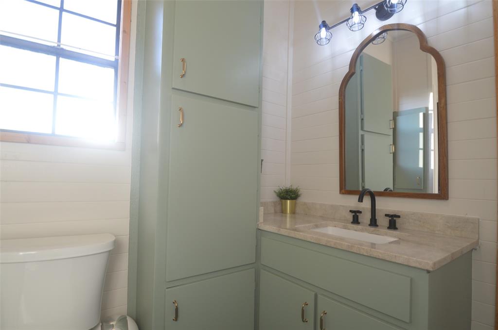 261 Red Road Howe, TX 75459 - Photo 24 of 40 a bathroom with a granite countertop sink a toilet and a mirror