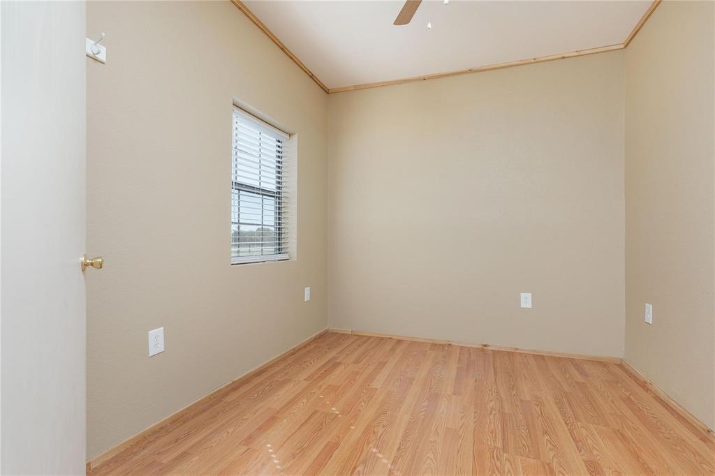 261 Red Road Howe, TX 75459 - Photo 26 of 40 a view of an empty room with wooden floor and a window