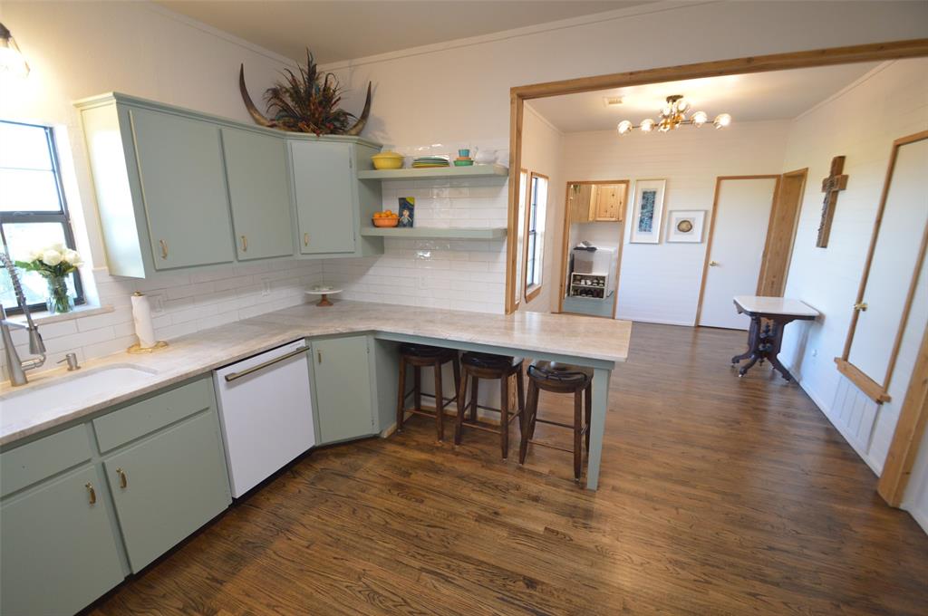 261 Red Road Howe, TX 75459 - Photo 7 of 40 a kitchen with granite countertop a sink cabinets and wooden floor