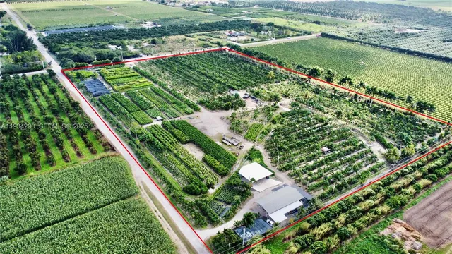 a view of a barn with wooden fence