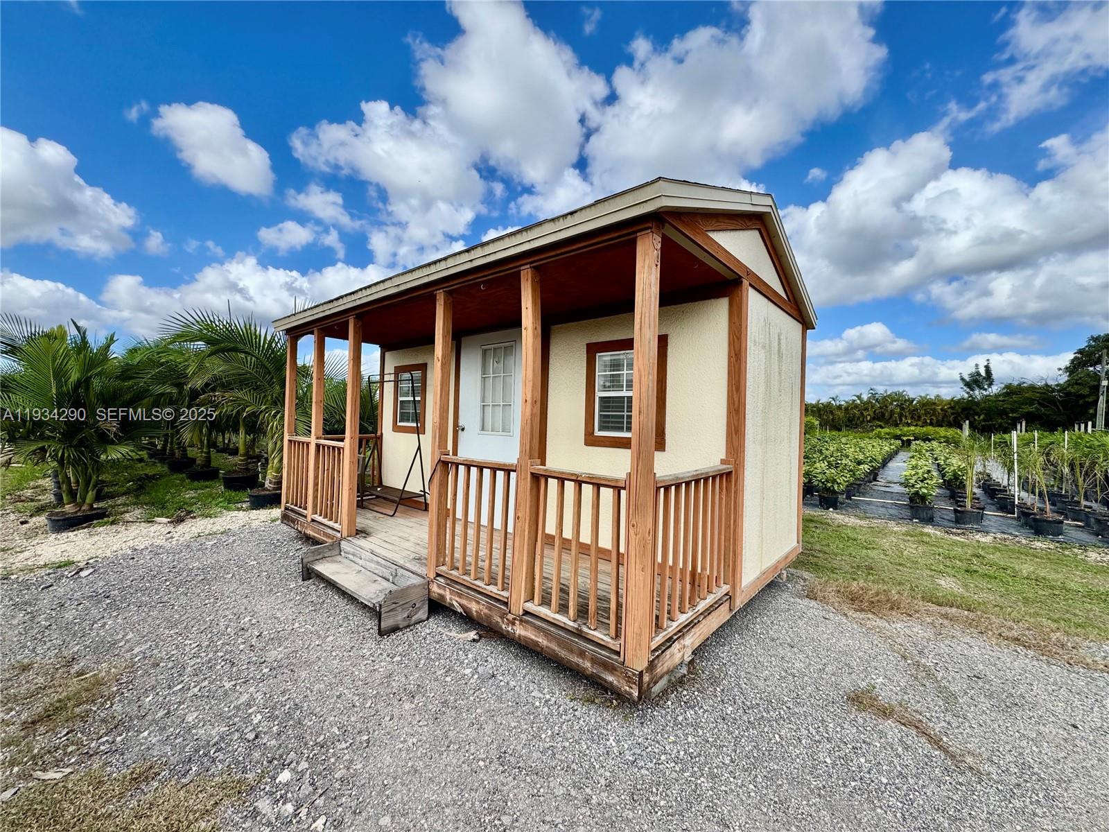 32800 Southwest 202nd Avenue Homestead, FL 33034 - Photo 6 of 25 a view of a house with wooden fence