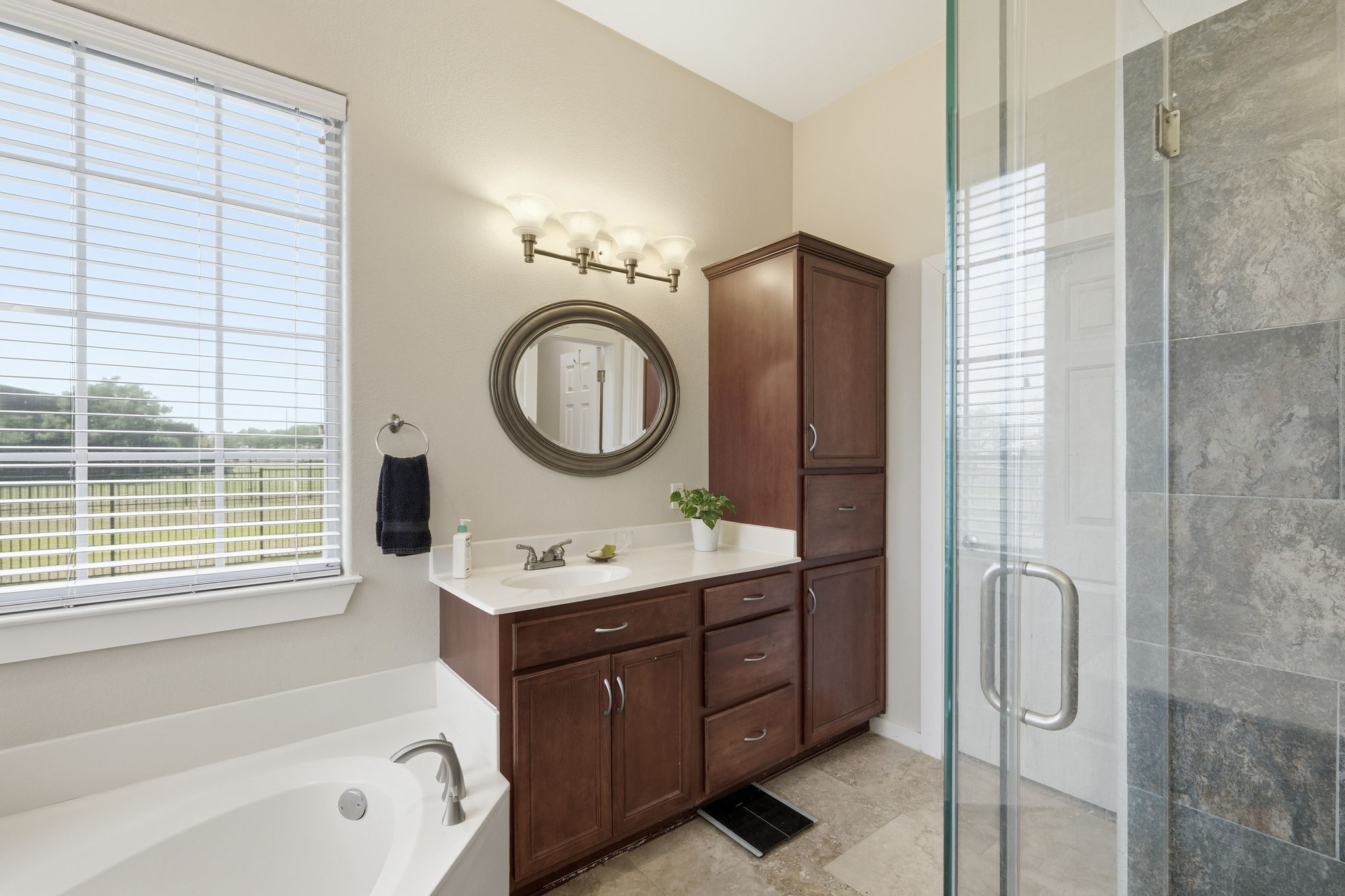 21007 Hodde Lane Pflugerville, TX 78660 - Photo 13 of 30 a bathroom with a bathtub sink vanity and mirror