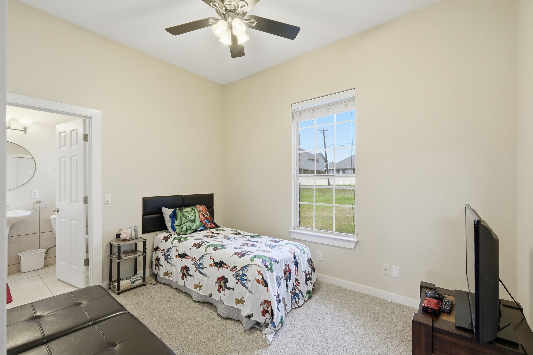 21007 Hodde Lane Pflugerville, TX 78660 - Photo 18 of 30 a bedroom with a bed and a flat tv screen on dresser