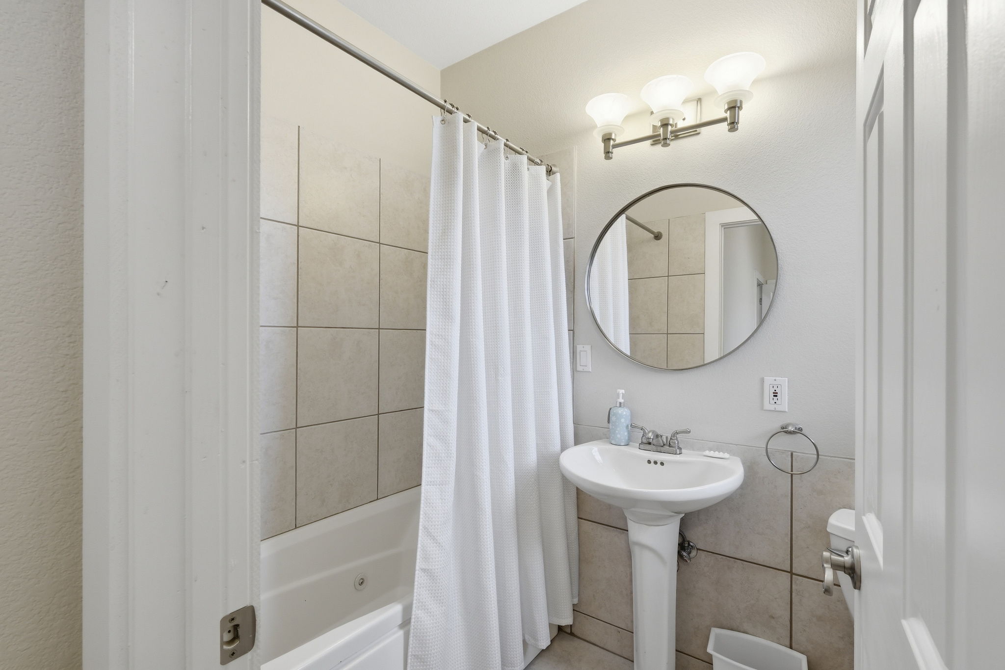 21007 Hodde Lane Pflugerville, TX 78660 - Photo 19 of 30 a bathroom with a sink a mirror and a shower