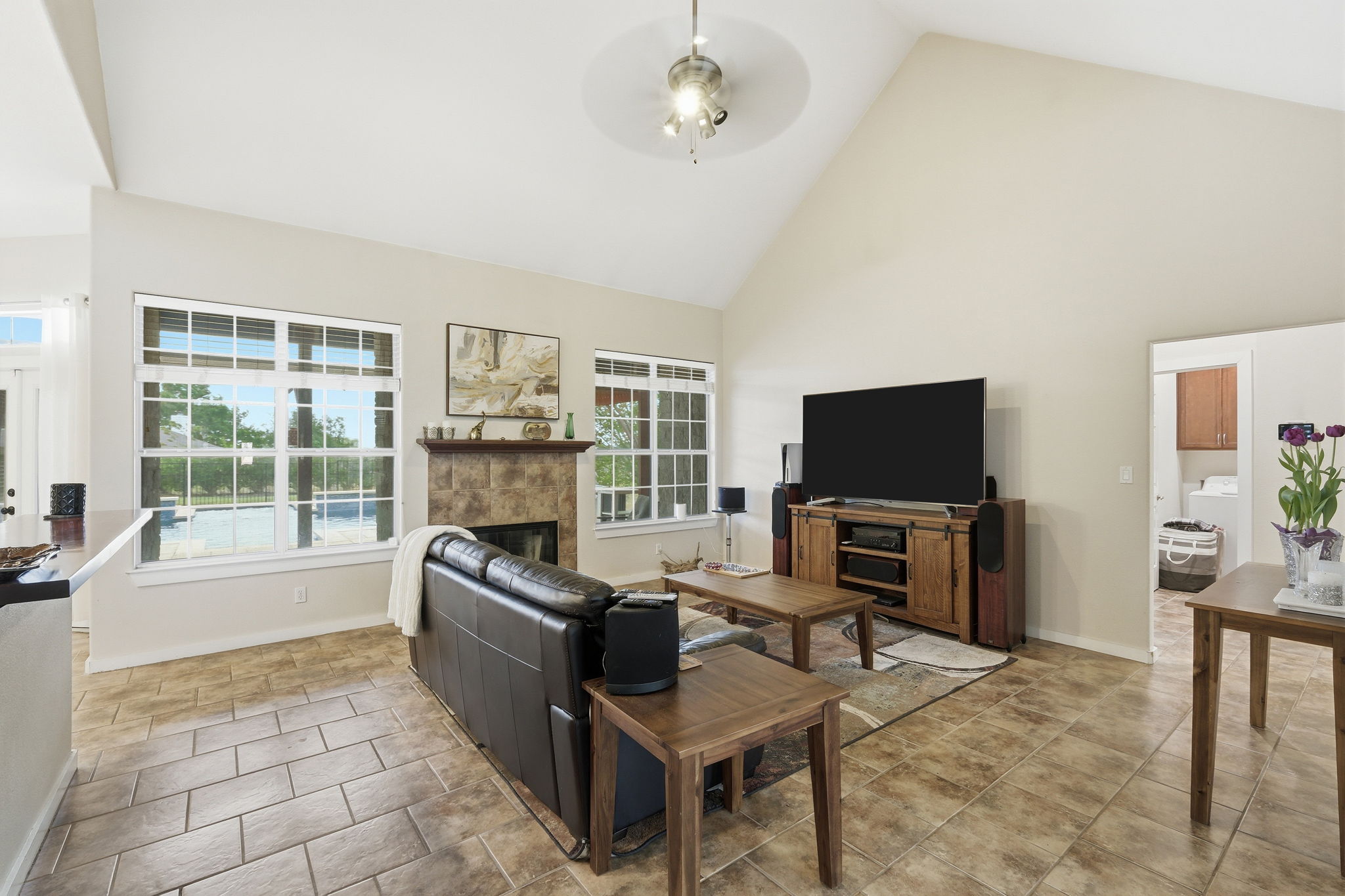 21007 Hodde Lane Pflugerville, TX 78660 - Photo 4 of 30 a living room with furniture a flat screen tv and a fireplace