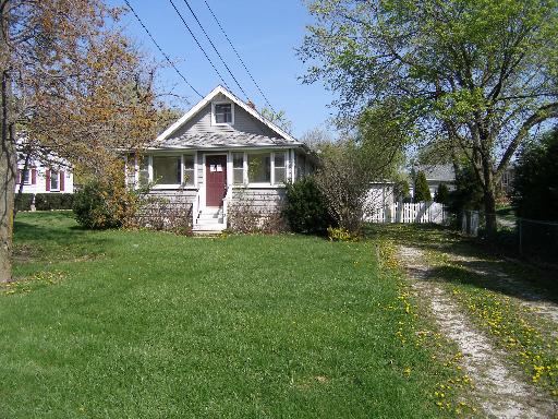 23W662 West Irving Park Road Roselle, IL 60172 - Photo 1 of 14 a front view of a house with garden
