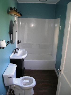 23W662 West Irving Park Road Roselle, IL 60172 - Photo 12 of 14 a bathroom with a sink a toilet and bathtub