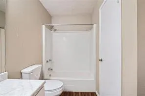 a bathroom with a toilet a sink and shower