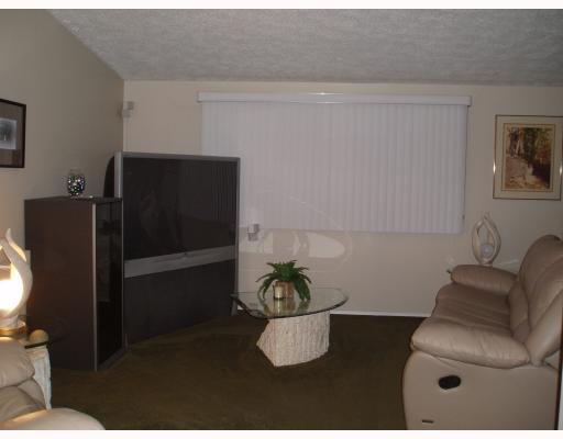Living Room. Huge Living Room offers wall to wall carpeting, nuetral decor, and window treatments included.