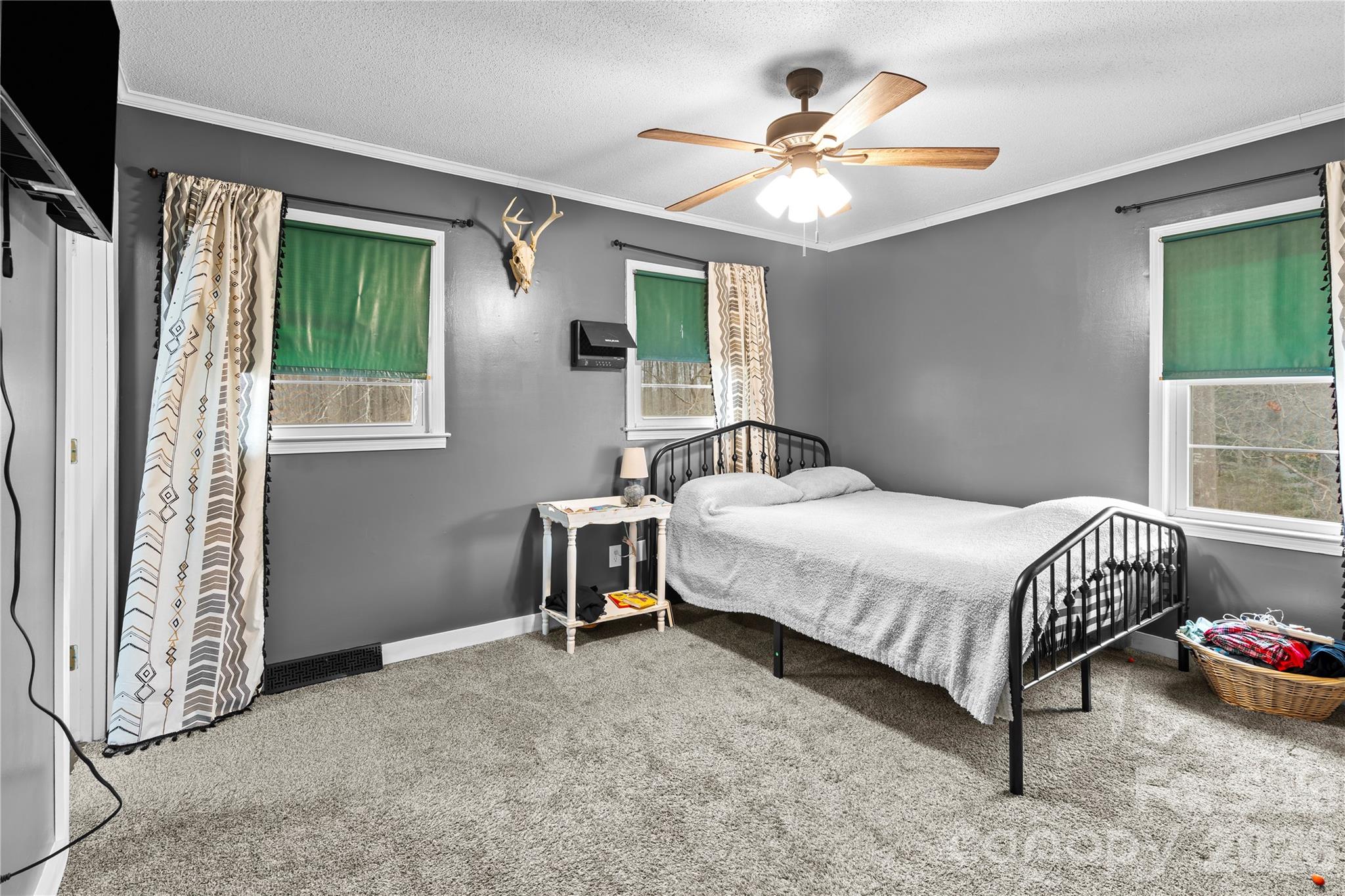 2231 Snuggs Park Road Albemarle, NC 28001 - Photo 15 of 30 a bedroom with a bed and a chandelier