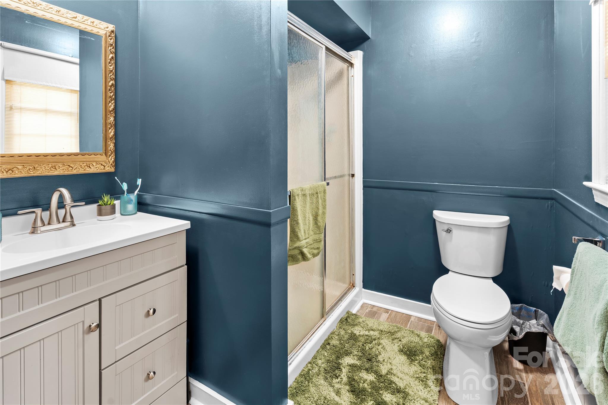 2231 Snuggs Park Road Albemarle, NC 28001 - Photo 16 of 30 a bathroom with a toilet sink and mirror