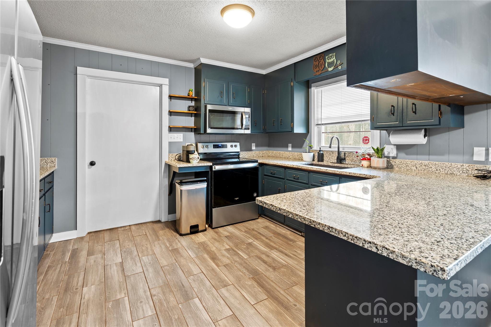 2231 Snuggs Park Road Albemarle, NC 28001 - Photo 9 of 30 a kitchen with stainless steel appliances granite countertop a sink stove and refrigerator