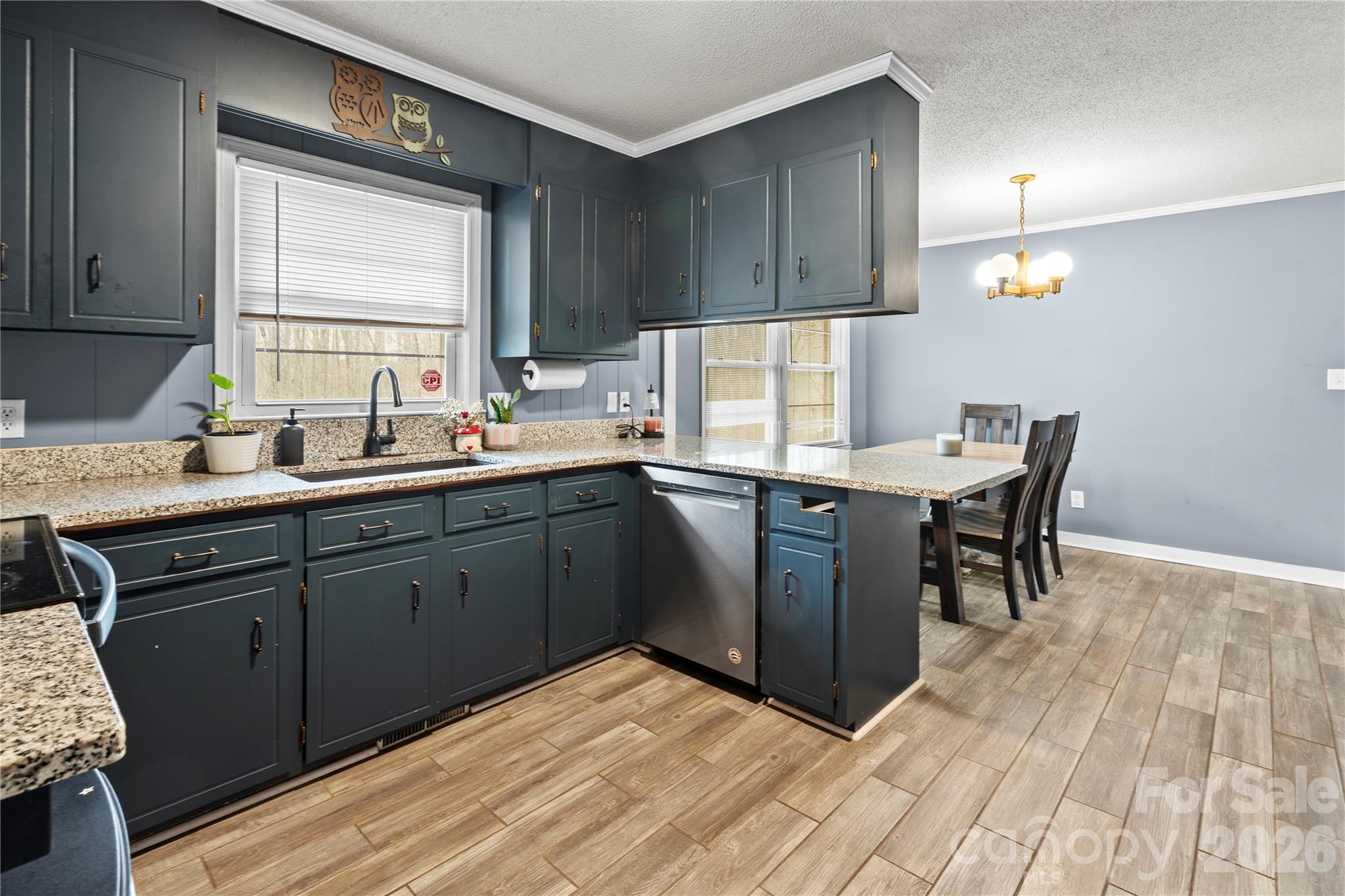 2231 Snuggs Park Road Albemarle, NC 28001 - Photo 10 of 30 a kitchen with a sink a window and cabinets