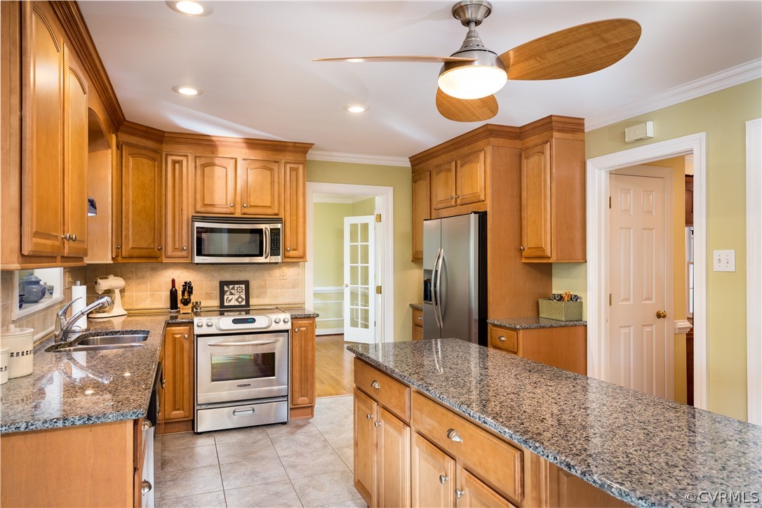 5705 North Chase Road Midlothian, VA 23112 - Photo 11 of 48 a kitchen with stainless steel appliances granite countertop a stove a sink and a refrigerator