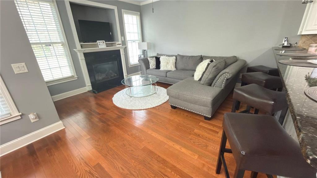2966 Everson Ridge Court Southwest Snellville, GA 30039 - Photo 3 of 15 a living room with furniture a fireplace and a flat screen tv