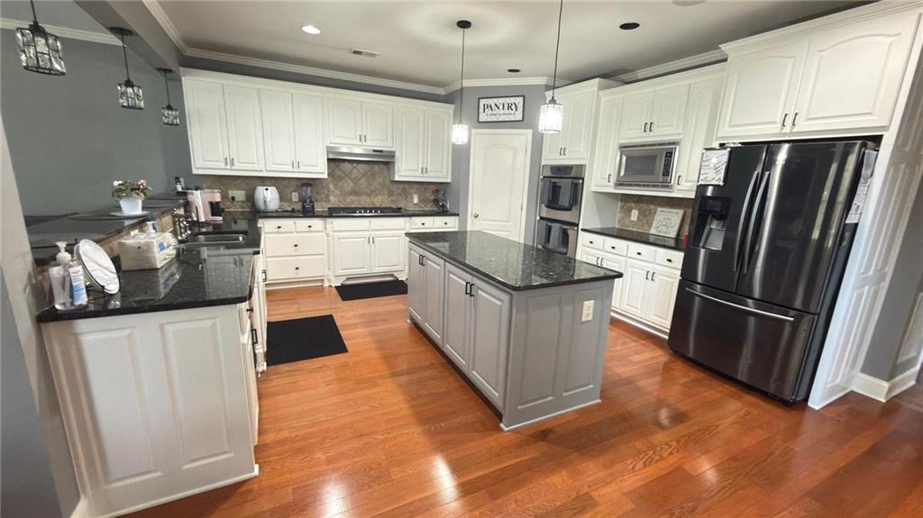 2966 Everson Ridge Court Southwest Snellville, GA 30039 - Photo 6 of 15 a kitchen with granite countertop a refrigerator stove top oven and sink