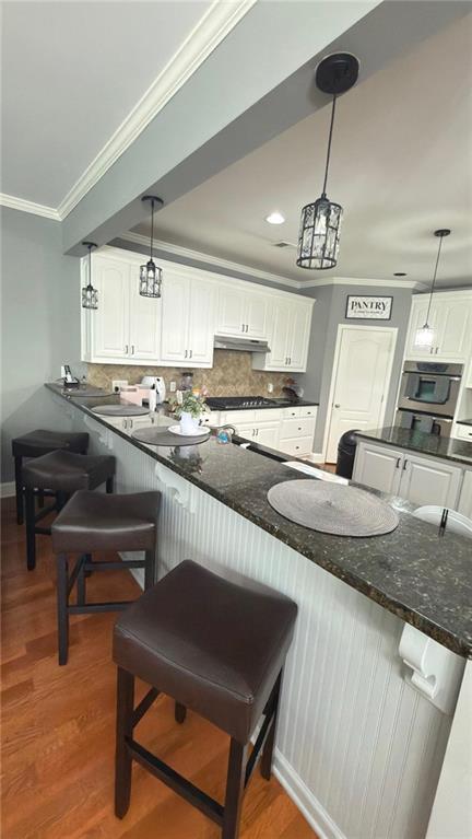 2966 Everson Ridge Court Southwest Snellville, GA 30039 - Photo 7 of 15 a kitchen with stainless steel appliances granite countertop a sink a stove and a refrigerator
