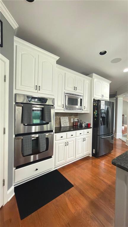 2966 Everson Ridge Court Southwest Snellville, GA 30039 - Photo 8 of 15 a kitchen with granite countertop white cabinets and stainless steel appliances