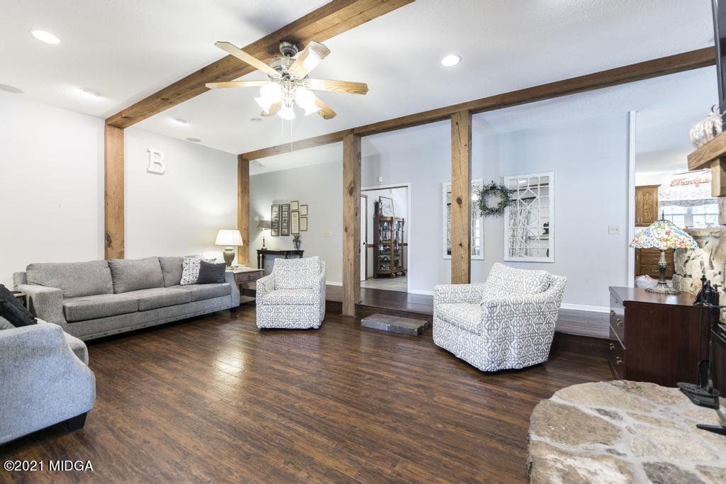 6246 Rogers Road Lizella, GA 31052 - Photo 16 of 48 a living room with couches and a dining table with wooden floor