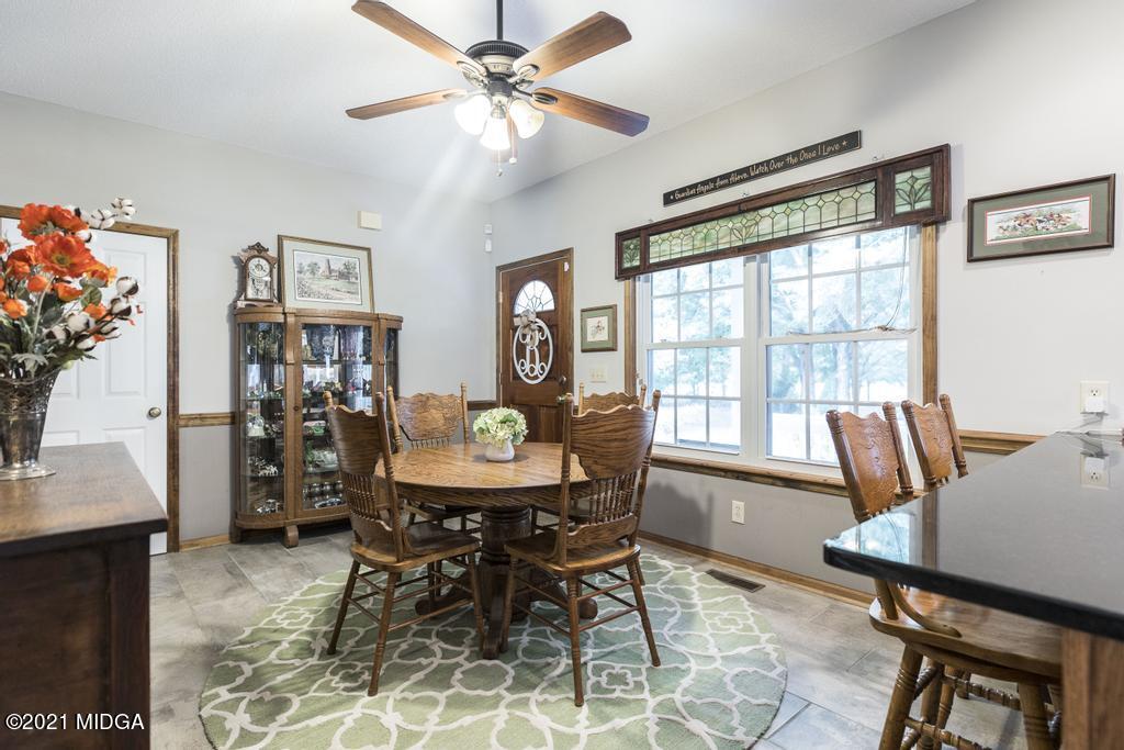 6246 Rogers Road Lizella, GA 31052 - Photo 17 of 48 a view of a dining room with furniture window and wooden floor