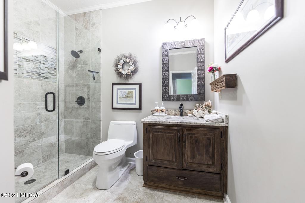 6246 Rogers Road Lizella, GA 31052 - Photo 27 of 48 a bathroom with a sink toilet and shower