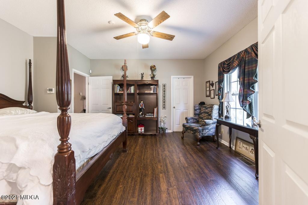 6246 Rogers Road Lizella, GA 31052 - Photo 34 of 48 a bed room with a bed and a chair
