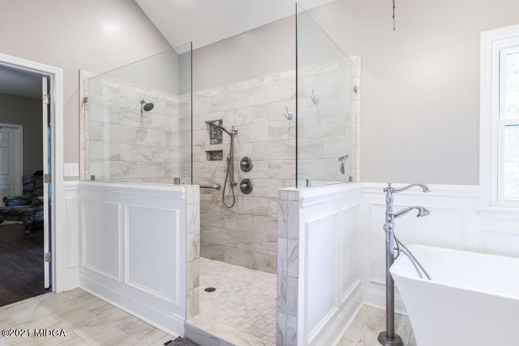 6246 Rogers Road Lizella, GA 31052 - Photo 37 of 48 a bathroom with a bathtub and a shower