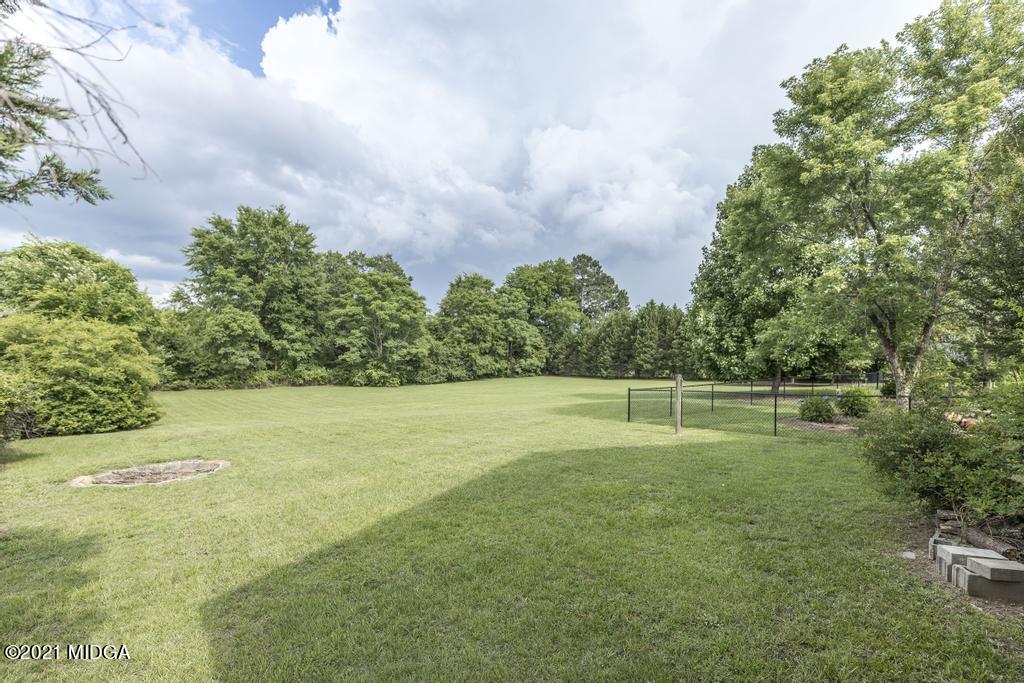 6246 Rogers Road Lizella, GA 31052 - Photo 44 of 48 a view of a big yard with potted plants and large trees