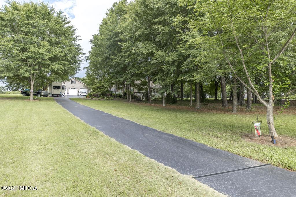 6246 Rogers Road Lizella, GA 31052 - Photo 47 of 48 a swimming pool with outdoor seating and yard