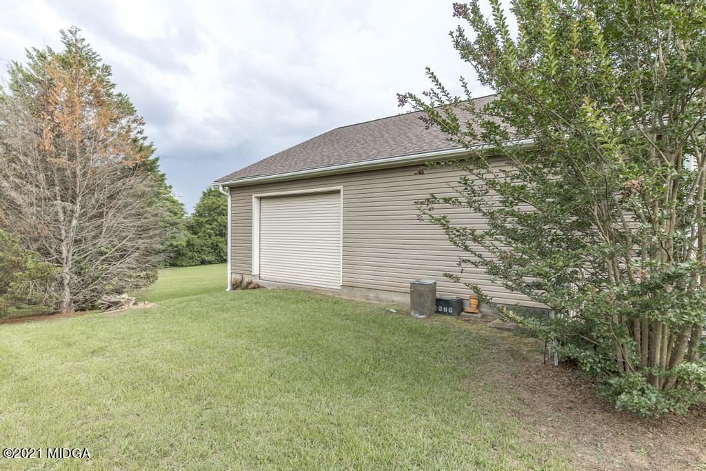 6246 Rogers Road Lizella, GA 31052 - Photo 8 of 48 a backyard of a house with large trees
