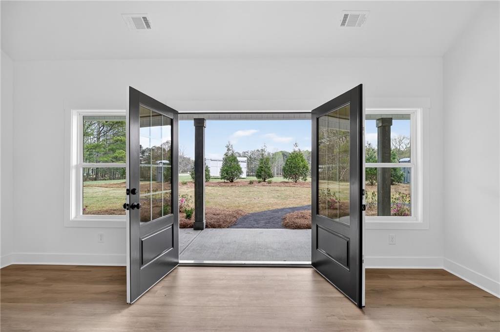 3512 Vinson Mountain Road Rockmart, GA 30153 - Photo 13 of 49 a view of an empty room with wooden floor and a window