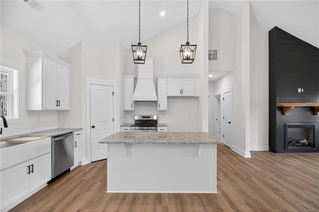 3512 Vinson Mountain Road Rockmart, GA 30153 - Photo 20 of 49 a large kitchen with granite countertop a sink a stove and cabinets