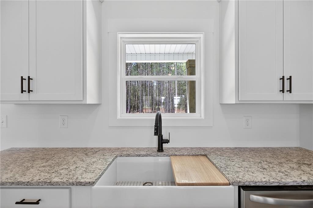 3512 Vinson Mountain Road Rockmart, GA 30153 - Photo 22 of 49 a kitchen with granite countertop a sink and white cabinets