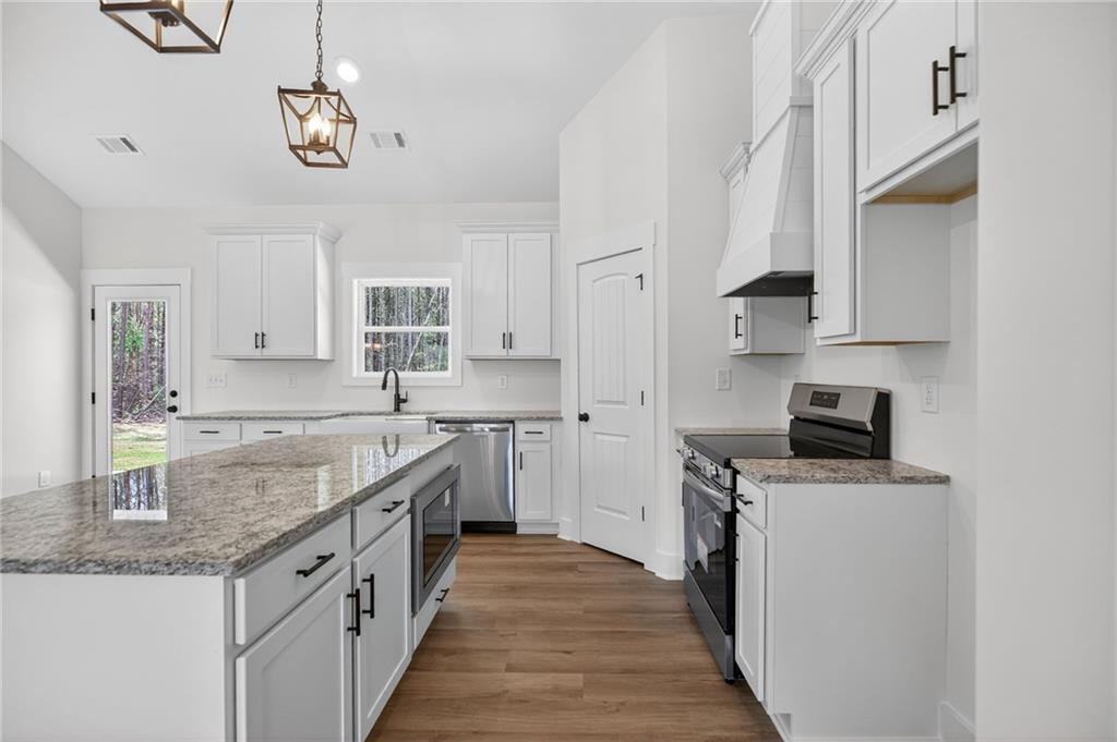 3512 Vinson Mountain Road Rockmart, GA 30153 - Photo 24 of 49 a kitchen with stainless steel appliances granite countertop a sink stove and refrigerator